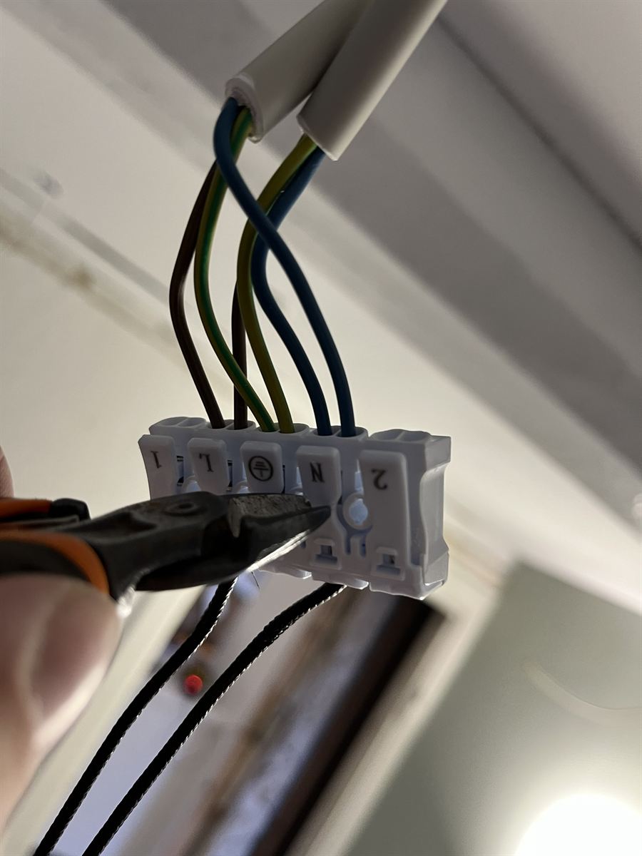 Live, neutral and earth conductors connected in a terminal block at a ceiling light point